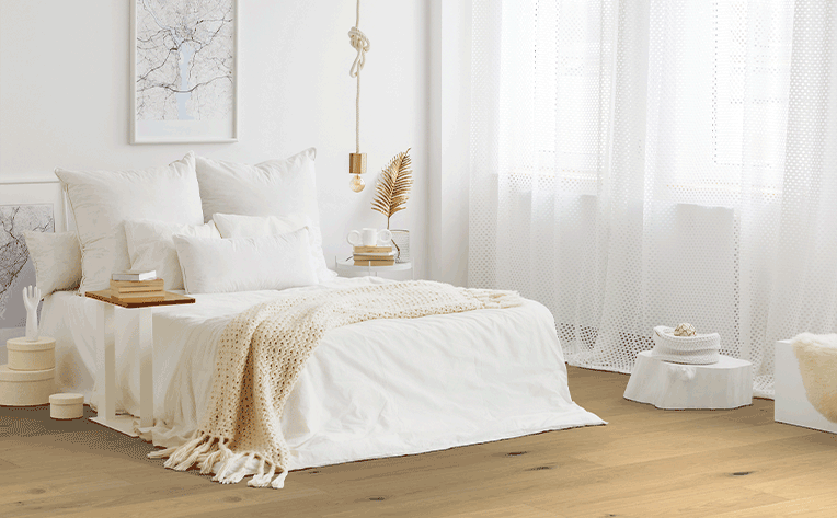 hardwood flooring with white bed and white curtains